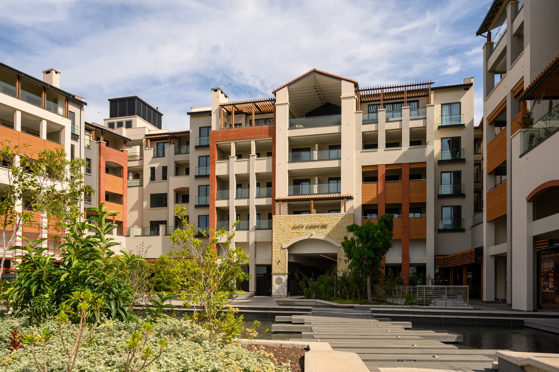 Modern apartment facades around a landscaped courtyard