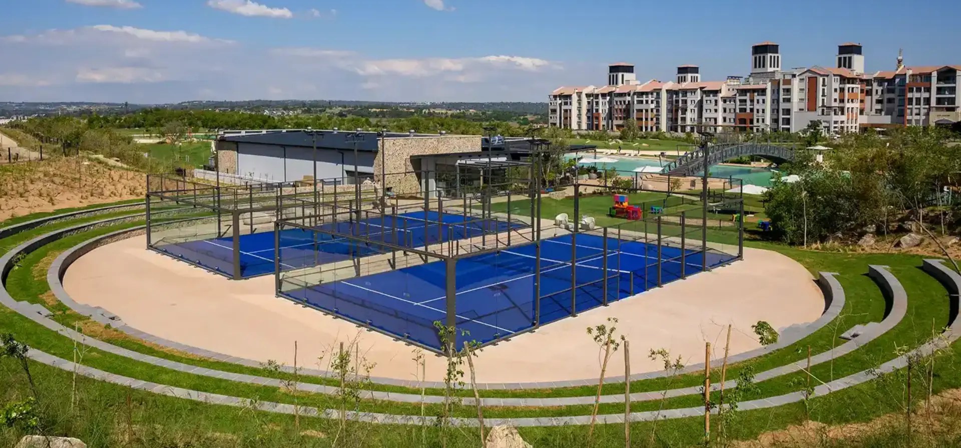 Padel tennis courts, clubhouse pavilion and apartment buildings at City Centre