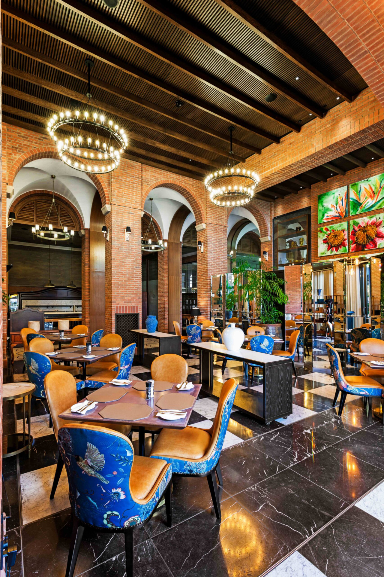 Clubhouse dining room with timber ceilings, brick arches and set tables
