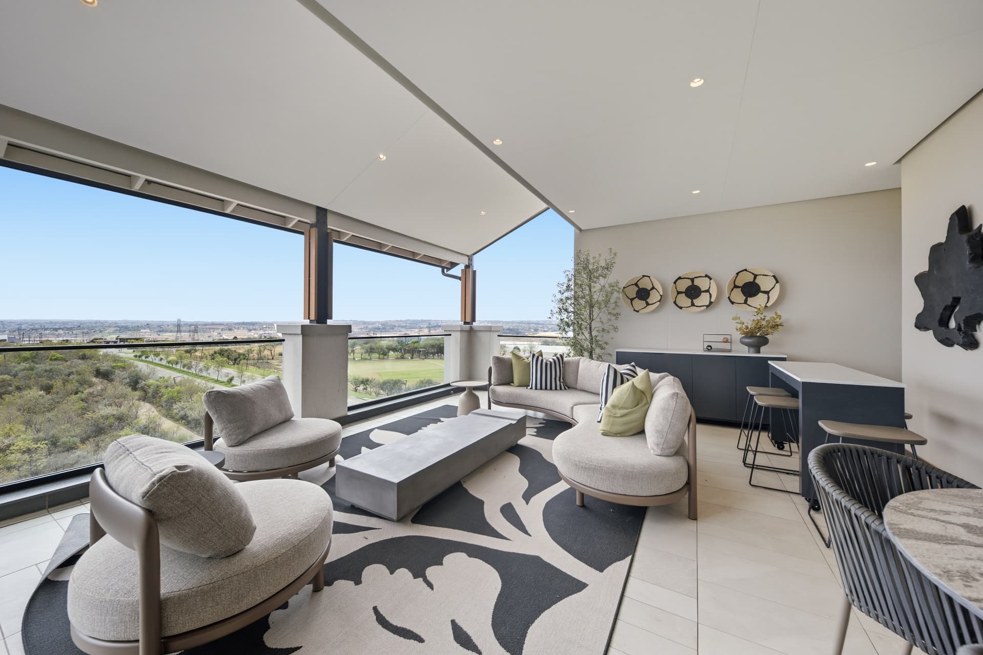 Covered terrace of a penthouse apartment with a parkland view